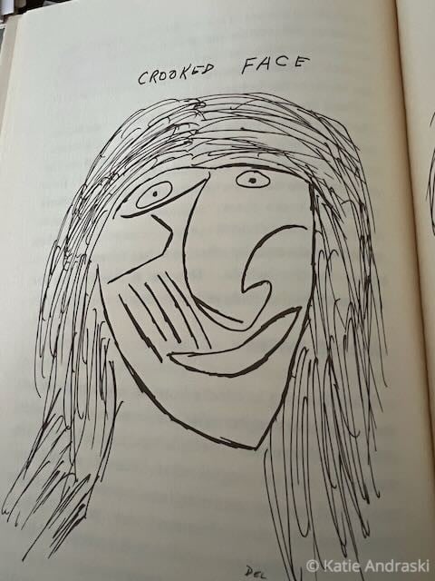 Abstract black-and-white drawing of a smiling face with long hair.