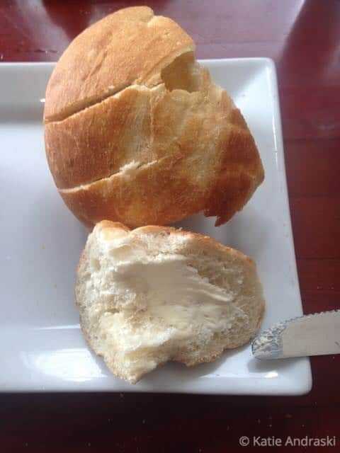 Two pieces of bread on a white plate.